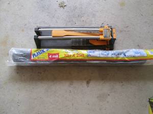 lot 145 image: Plastic sheeting and a tile cutter...