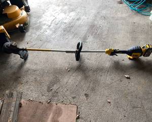 lot 233 image: DeWalt Battery Weed Wacker