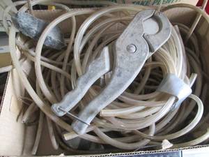 lot 37 image: Assorted Plastic and Rubber Hoses with Hose Cutter