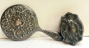 lot 94 image: Vintage Embossed Vanity Hand Held Mirror and Hand Brush
