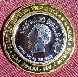 lot 295 image: Caesars Palace Casino Silver Strike $10 Gaming Token