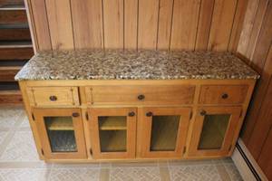 lot 67 image: Vintage Oak Buffet with Pebble-Stone Top and Glass Paneled Doors