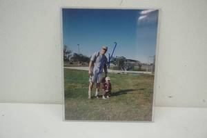 lot 156 image: Signed photo of pro baseball player and child