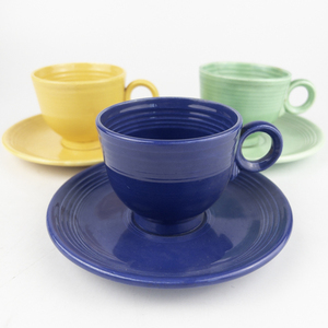 lot 36 image: Original Color FIESTAWARE&nbspSET OF THREE Ring Handle Teacup and Saucer Set in Original Cobalt Blue, Yellow, & Original Green Glaze  Circa 1937-1942