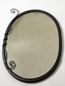 lot 140 image: Oval Mirror with decorative metal scrolls on frame. 26 inches high.