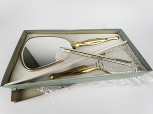 lot 325 image: VINTAGE Boxed Unused 3 piece vanity set. Ladies Vanity Dresser Hand Mirror, Brush and Comb. Gold color.