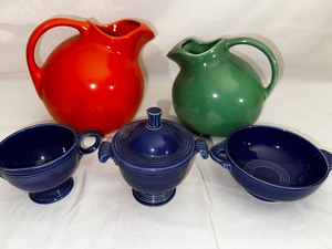 Two Vintage Fiestaware Water Pitchers in Orange and Green, Cobalt Sugar, Creamer, and Cream Soup Bowl