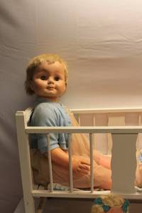 lot 29 image: Vintage Doll Collection with Cradle, Paper Dolls, and Plush Dog