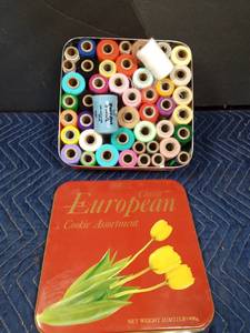lot 31 image: Tin of acrylic yarn spools