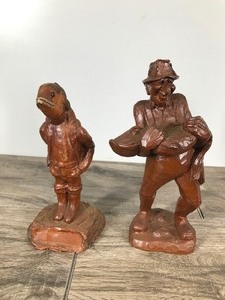 lot 283 image: 2 - Wooden Statues  Man with a Fish Head and a Old Man Carrying a Fish