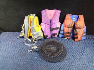 lot 56 image: 3 childrens life jackets and a fish holding basket