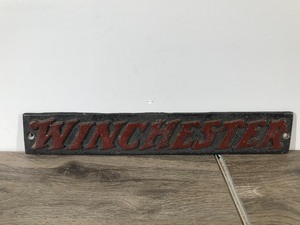 lot 556 image: Heavy Duty Cast Iron Wall Hanging Winchester Sign