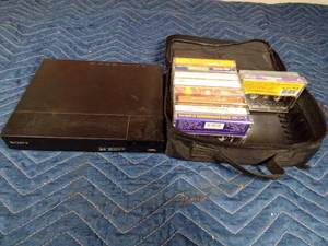 lot 142 image: DVD player and cassettes in a case