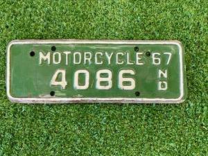 lot 97 image: 1967 ND Motorcycle License Plate