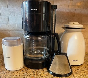 lot 38 image: Coffee Lovers LOT - Krups 10 Cup Coffee Maker, Insulated Carafe, Coffee Grinder, Two Reuseable Filters, Four Crate and Barrel Coffee Cups