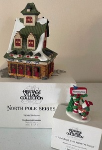 lot 57 image: Retired Dept. 56 North Pole Series Reindeer Barn and Trimming the North Pole with Original Boxes