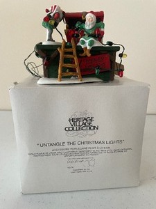 lot 49 image: Dept. 56 Heritage Village Series Untangle the Lights Porcelain, Lighted 2 of 2