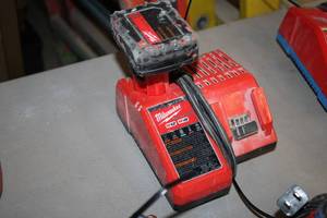 lot 399 image: Milwaukee M12M18 Battery Charger with M12 Red Lithium XC Battery
