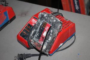 lot 401 image: Milwaukee M12M18 Battery Charger with M18 Red Lithium Battery