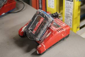 lot 403 image: Milwaukee M12M18 Battery Charger with M18 Red Lithium CP 1.5 Battery