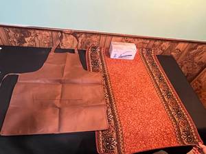 lot 85 image: Table Runner, Apron, and Steamfast SF-710 Mini Steam Iron