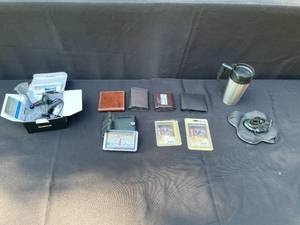 lot 279 image: Assorted Items Lot Featuring Garmin 1300 LMT GPS, Wallets, Travel Mug and More