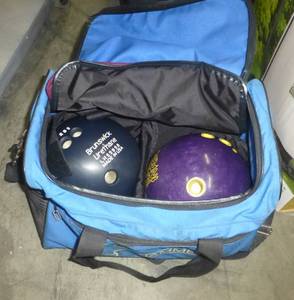 lot 58 image: Two Brunswick bowling balls in a carrying bag