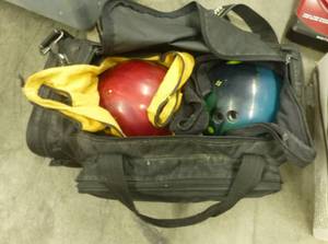 lot 59 image: Two Brunswick bowling balls in a carrying bag, and individual ball bags