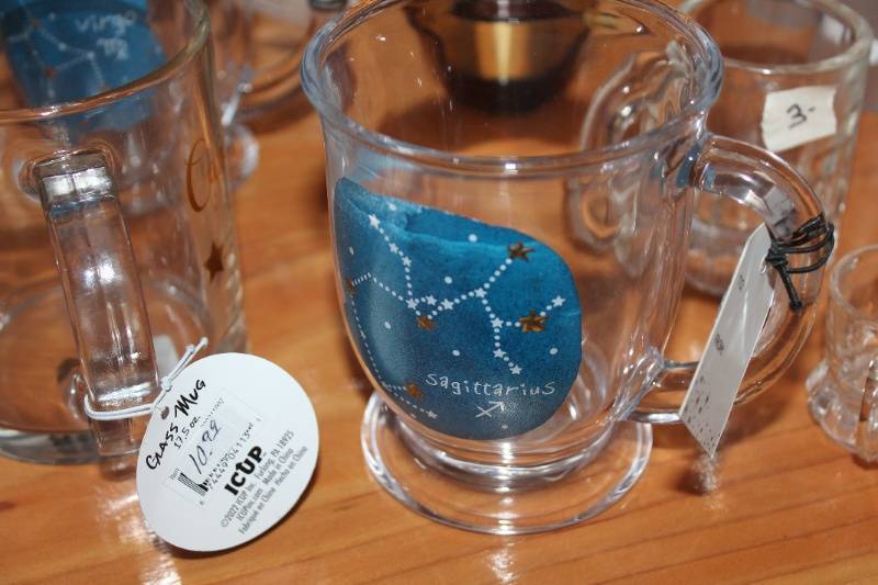 lot 84 image: Assorted Glassware Collection - Zodiac Mugs, Flamingo Glasses, and Themed Shots