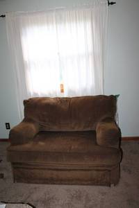 lot 94 image: Brown Upholstered Chair with Plush Cushions