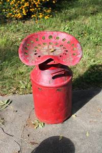 lot 101 image: Vintage Red Tractor Seat Mounted on Milk Can Base