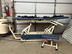 lot 17 image: MSRP $5000 Chattanooga Tru-Eze E-600320 Tru-Trac Power Variable Height Adjustment Treatment Traction Table with Stool & Hand Control - Makes An Amazing Massage Table Ink Bed Too End Piece Is Removable Great Working Condition