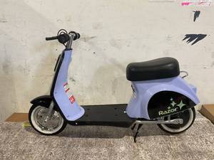 lot 91 image: Razor Pocket Mod Petite - Purple, 12V Miniature Euro-Style Electric Scooter, up to 8 mph, for Ages 7