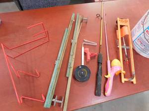 lot 138 image: Lot of fishing poles, ice scoops, rod holders.