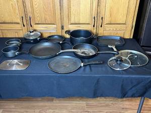 lot 38 image: Assorted cookware lot including pans, pots, and lids