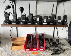 lot 200 image: (6) Walkie-talkies and desktop chargers (6) Motorola SpeakerMics Spare parts