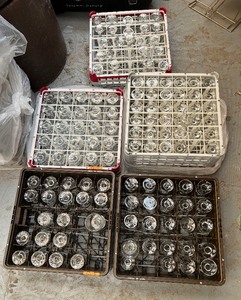 lot 181 image: Wine or water goblets in 5 Racks, roughly 25 glasses per rack.
