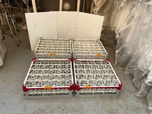 lot 187 image: Champagne glasses and water goblets 85-100 in total. Gray racks are Vollrath