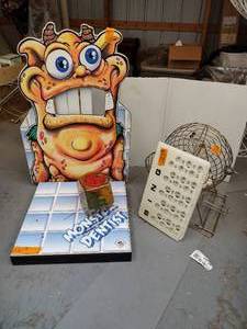 lot 221 image: Monster Dentist tabletop style carnival game. Bingo ball spinner cage with molded master board