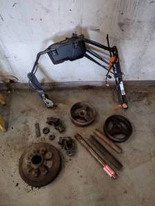 lot 261 image: Excavator windshield (no glass included) and other assorted parts, wheels, gears, and metal poles