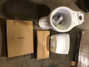 lot 48 image: Delta Foundations 2-Piece 1.1 GPF1.6 GPF Dual Flush Elongated Toilet in White   Customer Returns See Pictures