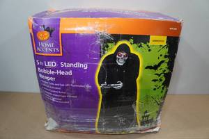 lot 122 image: Home Accents 5 Motion Activated Standing Bobble Head Reaper
