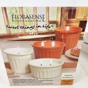 lot 44 image: Florasense 4 Piece Candle Gift Set Vanilla Shortbread Pumpkin Tart Two Tapered Gift Sets White Candle