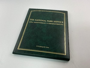 lot 3 image: The National Park Service 100th Anniversary Commemorative Coin and Stamp Trifold Folio with Silver Dollar