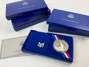 lot 21 image: 4x 1986 Silver Commemorative Dollars