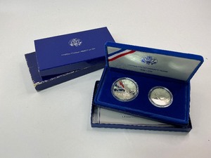 lot 32 image: 2x 1986 2pc Silver Commemorative Dollar and Clad Half Dollar