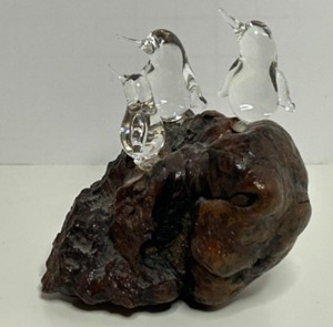 lot 99 image: Artisan Handblown Clear Glass Penguins On A Burlwood Base Sculpture