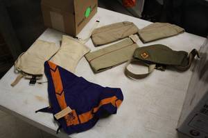 lot 966 image: Lot of  Boy Scout Equipment - (4) Hats, (1) Set of Seats, (1) Scarf, (1) Belt