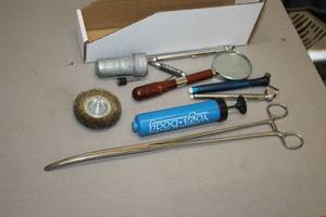 lot 995 image: Lot of (12) Assorted Hand Tools - Tire Gauges, Misc. Rotary Tool Bits, Magnifying Glass, Hand Pump, Battery Terminal Cleaner