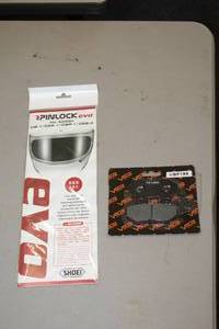 lot 1001 image: Volar Motorsports Brake Pads VBP195 and Evo Helmet Visor Cover for Shoei